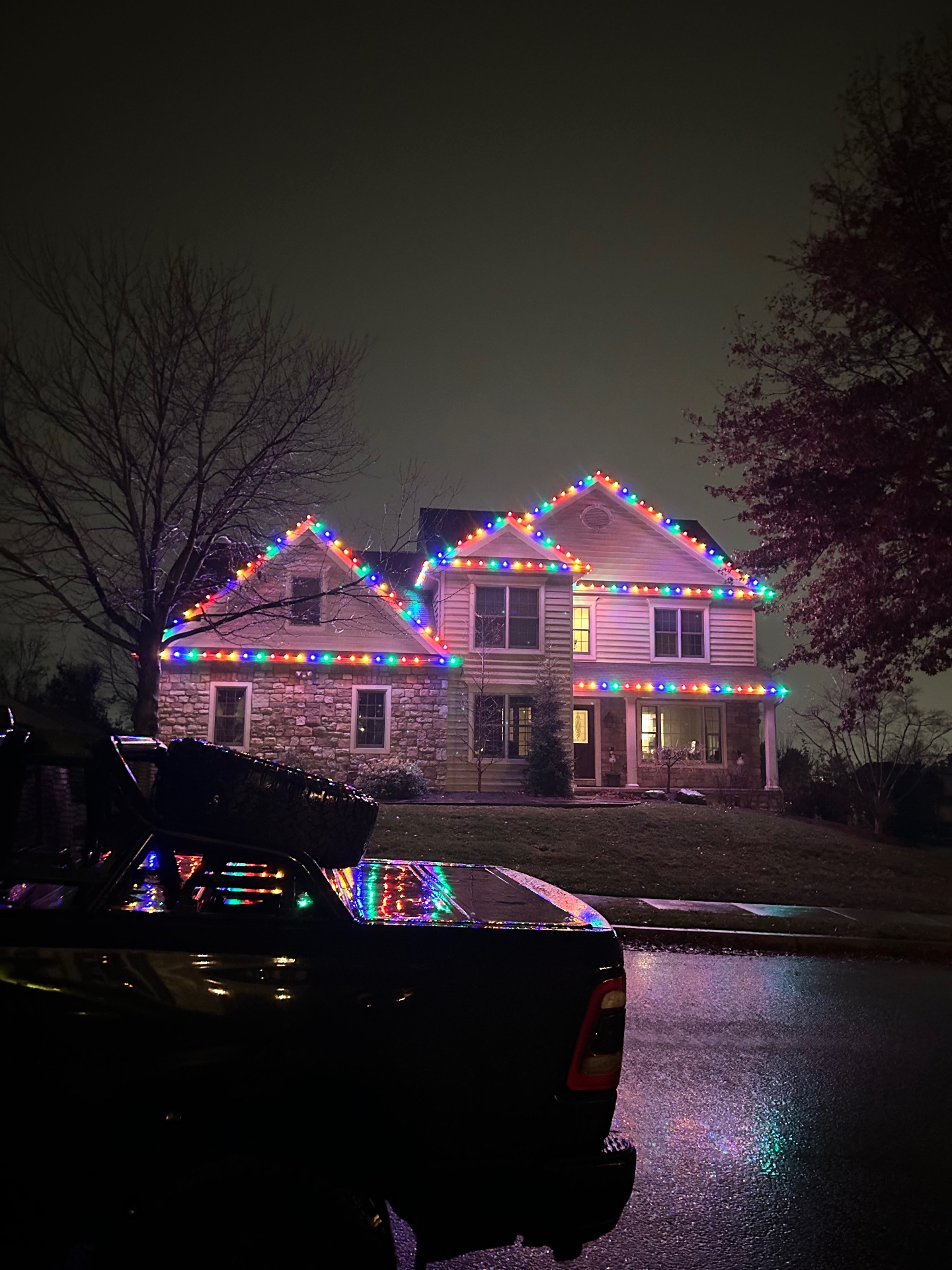 Stone home in York PA outlined with multicolor LED holiday lights